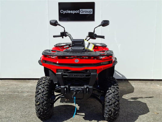 A red and black 2026 CFMOTO CFORCE C5 EPS ATV is photographed from the front, parked on asphalt in front of a white wall with a 'Cyclespot Group' sign above it.