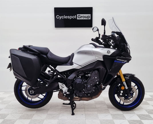 2021 Yamaha Tracer 9 GT motorcycle on display with 'Cyclespot Group' sign in the background