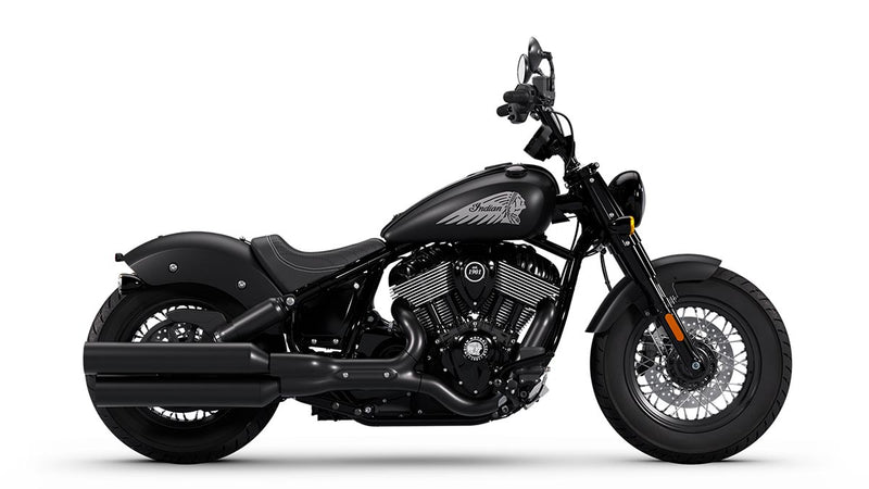 Load image into Gallery viewer, A black Indian Chief Bobber Dark Horse cruiser motorcycle with chrome engine components, a high handlebar, and a low-slung seat, shown in a side profile on a white background.
