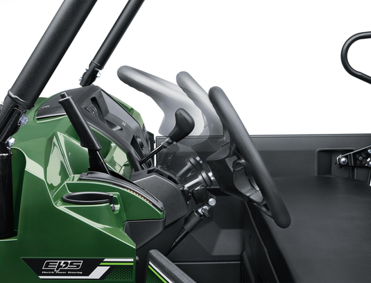 Close-up of a green side x side interior with steering wheel and dashboard.