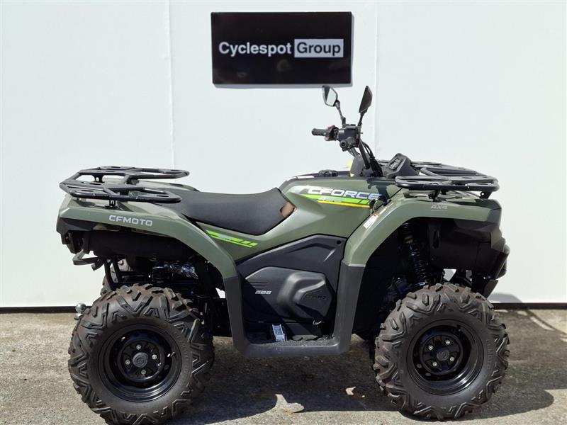 Load image into Gallery viewer, A 2025 CFMoto CFORCE 400, in Hunter Green, all-terrain vehicle (ATV) parked in front of a white wall with a 'Cyclespot Group' sign above it.

