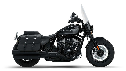 A black 2026 Indian Super Chief Dark Horse motorcycle with a tall clear windshield, black saddlebags, and chrome details, photographed from a side profile against a solid white background.
